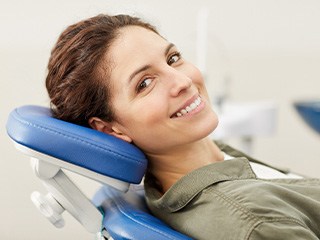Female patient leaning back in dental chair in oral surgeon’s office