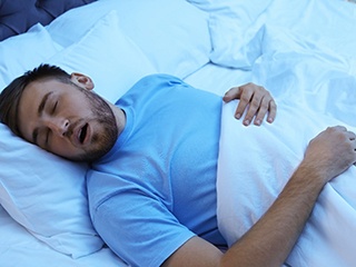 Snoring man, may be suffering from sleep apnea