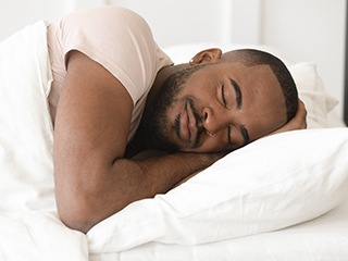 Man sleeping well with help of sleep apnea treatment