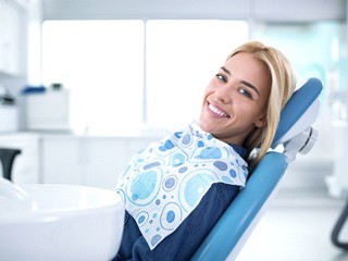 young woman smiling during dental checkup in Ponte Vedra Beach
