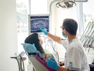 dentist going over a patient’s X-rays during a checkup
