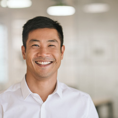 Man in white button-up shirt smiling