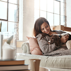 Woman relaxing at home with dog