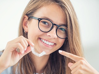 Woman with glasses pointing to Invisalign in Ponte Vedra Beach, FL