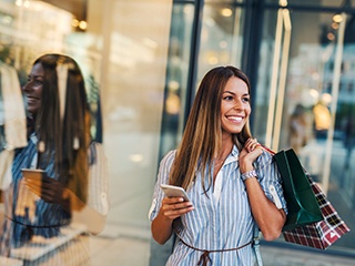 Woman smiling while shopping outside