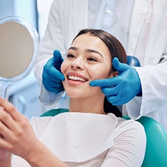 Patient smiling at reflection in mirror