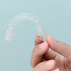 Patient holding clear aligner