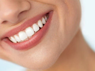 Closeup of woman with white teeth smiling