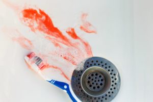 blood in sink beside toothbrush