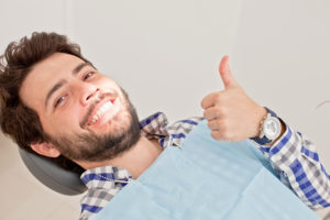 man smiling in the dental chair