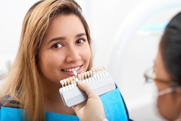 Patient at dentist’s office receiving porcelain veneers.