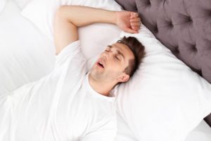 Man snoring because of his sleep apnea.