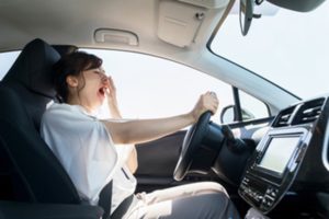 Woman yawning while driving.