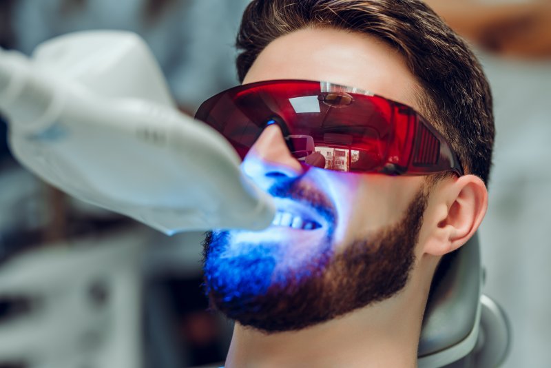 A man getting teeth whitening, an example of non-invasive cosmetic dentistry