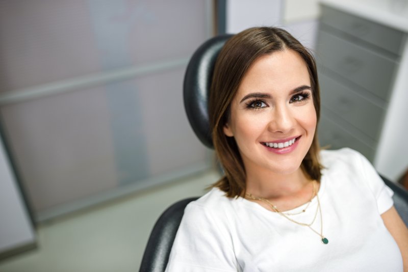 person smiling after being treated by cosmetic dentist