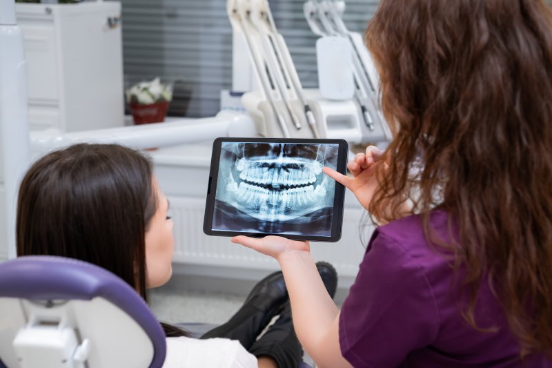 Patient talking to dentist about dental implants