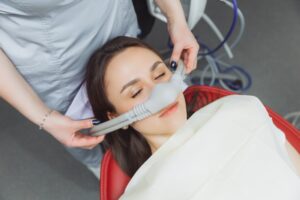 a woman receiving nitrous oxide sedation at the dental office