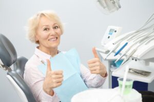 Senior smiling and holding two thumbs up
